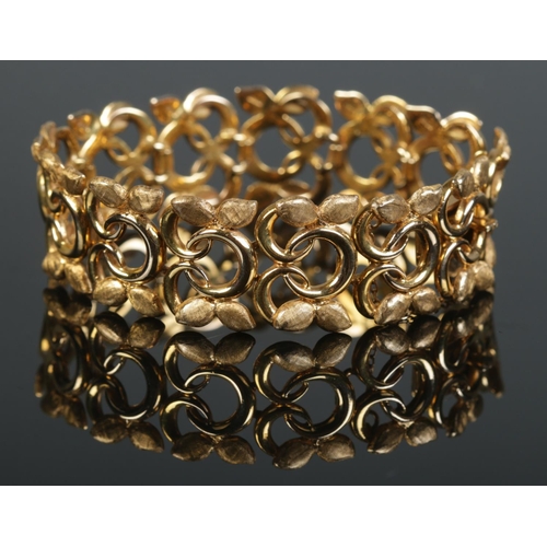 109 - A 9ct gold textured bracelet of floral design, by Cropp & Farr. 35.39g.
