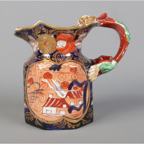 11 - An early 19th century Masons Ironstone jug decorated in the School House design and having dragon ha... 