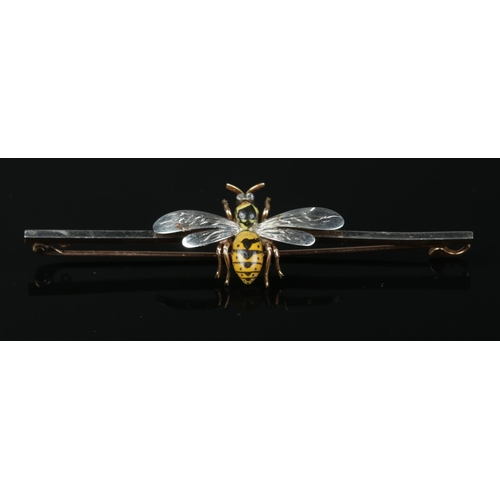 117 - A 15ct gold and platinum bar brooch surmounted with a wasp, having enamelled decoration and diamond ... 