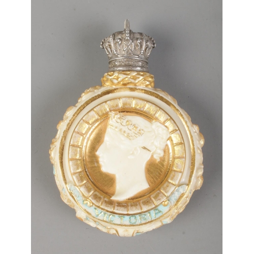 12 - A blush ivory scent bottle commemorating Queen Victoria's 1887 Golden Jubilee. Having white metal sc... 