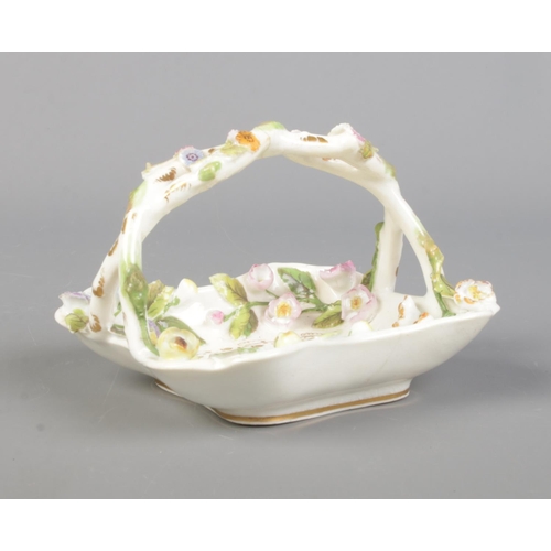 14 - A Rockingham porcelain encrusted miniature basket. Puce Griffin mark to base, circa 1830-1842. Lengt... 