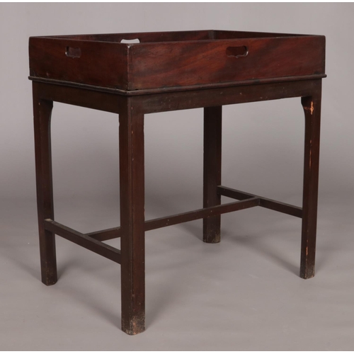 146 - A 19th century mahogany tray to table raised on four square cut legs.