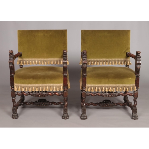 152 - A pair of Louis XIII style carved arm chairs with velvet upholstery and carved lion mask decoration.... 