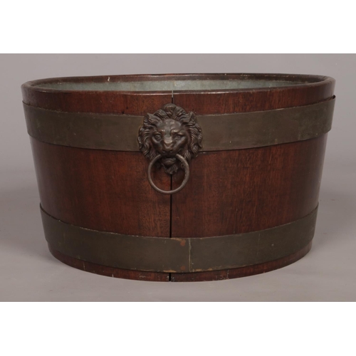 153 - A mahogany wine cooler with twin lion mask handles and raised on four cabriole supports. Height 58cm... 