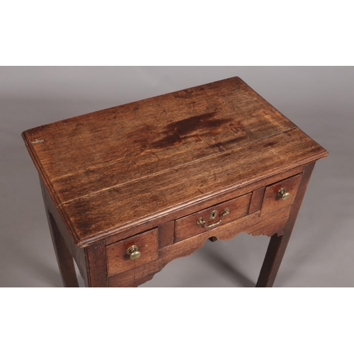 156 - A Georgian oak side table, having three drawers and raised on square cut legs. Height 75cm, Width 76... 