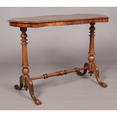158 - A Victorian burr walnut centre table. With quarter veneered top and raised on turned and carved supp... 