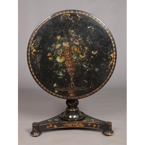159 - A 19th century lacquered tilt top table with painted floral and gilt decoration. Diameter of top 76c... 