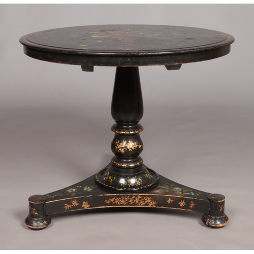 159 - A 19th century lacquered tilt top table with painted floral and gilt decoration. Diameter of top 76c... 