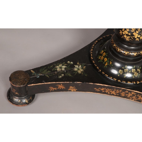 159 - A 19th century lacquered tilt top table with painted floral and gilt decoration. Diameter of top 76c... 