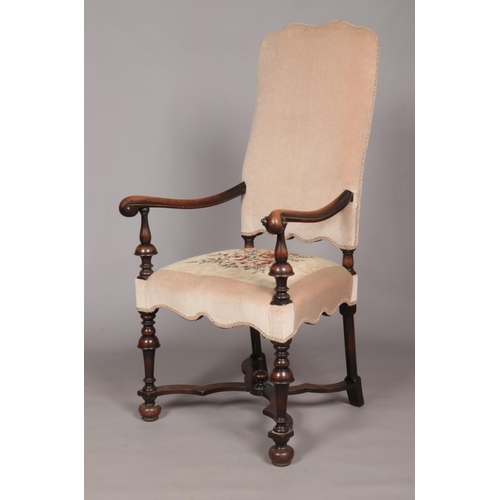 160 - An early 19th century carved walnut upholstered arm chair. Having x-frame stretcher with centre fini... 