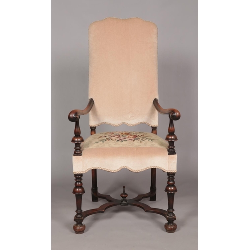160 - An early 19th century carved walnut upholstered arm chair. Having x-frame stretcher with centre fini... 