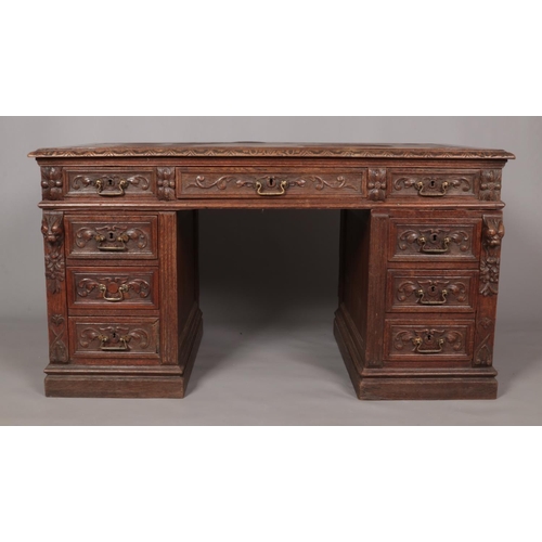 161 - A Victorian carved oak twin pedestal desk. Height 77cm, Width 140cm, Depth 77cm.