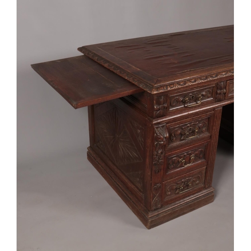 161 - A Victorian carved oak twin pedestal desk. Height 77cm, Width 140cm, Depth 77cm.