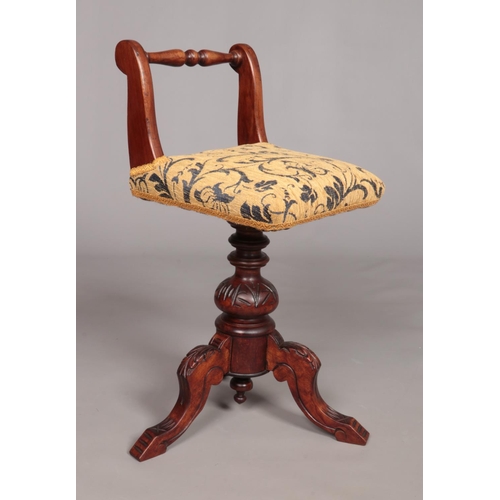 164 - A Victorian carved mahogany piano stool. Having upholstered seat and turned back rest. Height 68.5cm... 