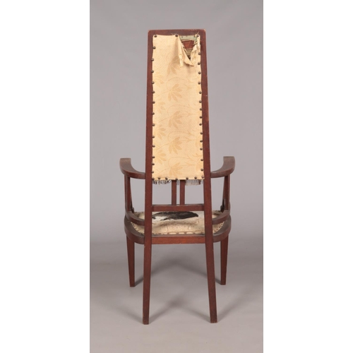 167 - An Arts & Crafts oak arm chair. Height of back 125cm.