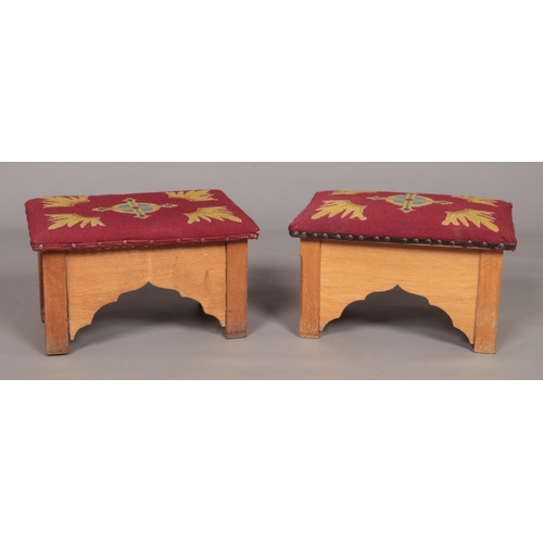 169 - A small pair of oak prayer stools with embroided seats. Height 30cm, Width 48cm, Depth 32cm.