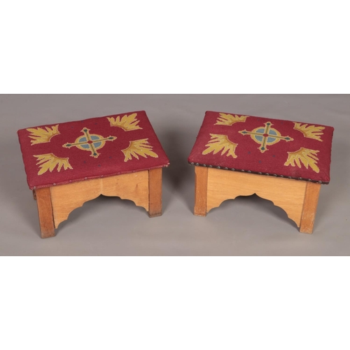 169 - A small pair of oak prayer stools with embroided seats. Height 30cm, Width 48cm, Depth 32cm.