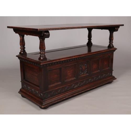 171 - A carved and panelled oak monks bench. Height (with back up) 120cm, Length 101cm, Depth 50cm.