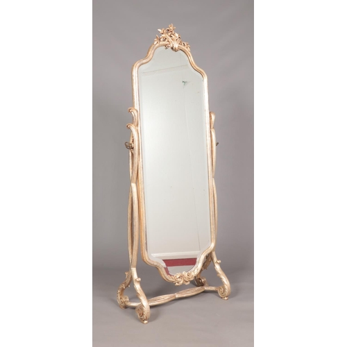 173 - A decorative carved silvered giltwood cheval mirror. Height 175cm, Width 72cm.