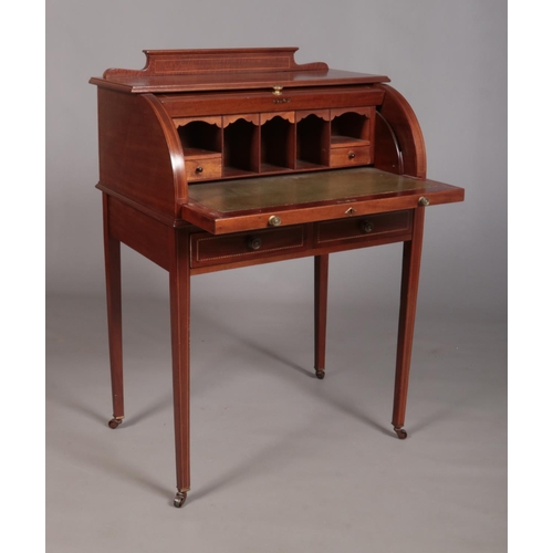 186 - An Edwardian mahogany cylinder desk, having fitted interior, tapering supports and strung inlay. Hei... 