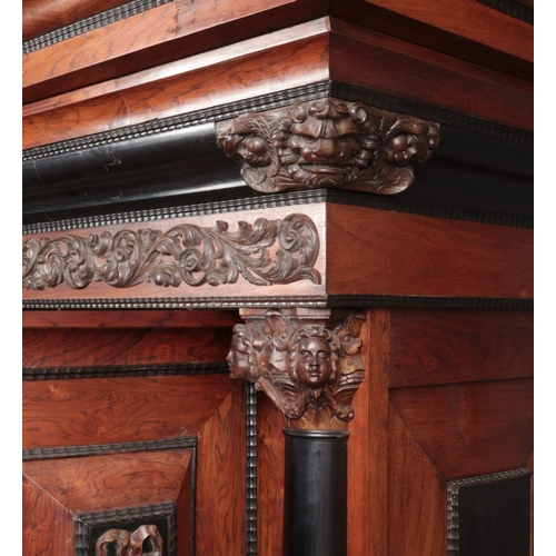 189 - A rosewood and ebonised Schrank with applied carved decoration in the Baroque style. Having two pane... 
