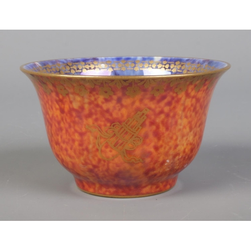 19 - A Wedgwood Lustre miniature bowl by Daisy Makeig Jones, decorated with motifs. Having mottled orange... 