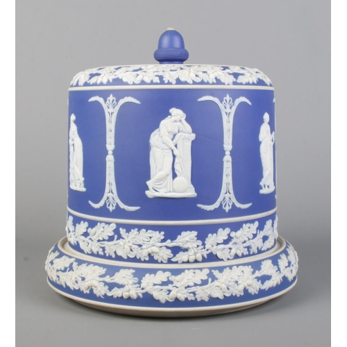 22 - A large 19th century Jasperware cheese dome. Having acorn finial and decorated with classical figure... 