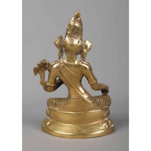 37 - A Sino Tibetan cast gilt metal figure of a seated deity. Height 17.5cm.