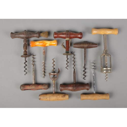 45 - A collection of vintage and antique corkscrews. All having turned wooden handles.