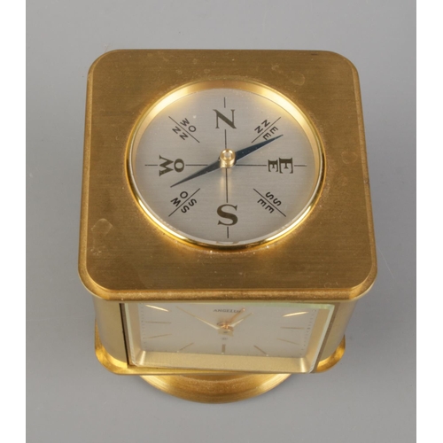 57 - A vintage brass Angelus desk clock/weather station. Having rotating cube shaped body with alarm cloc... 