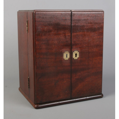 59 - A late 18th/early 19th century mahogany medicine cabinet with brass mounts. Having fitted interior a... 