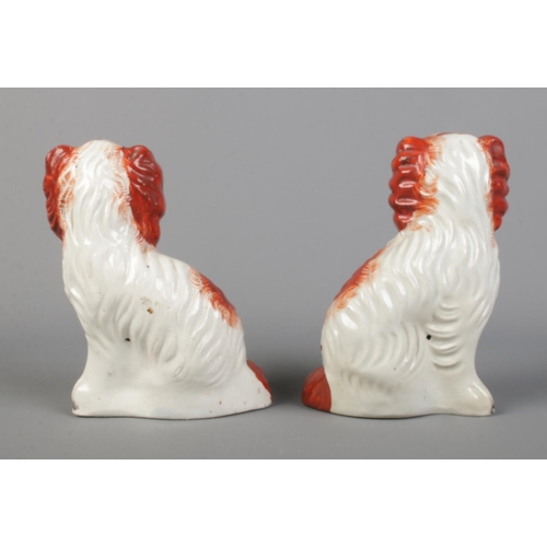 6 - A pair of Victorian Staffordshire pottery Spaniels in red, size No. 2. Height 16cm.