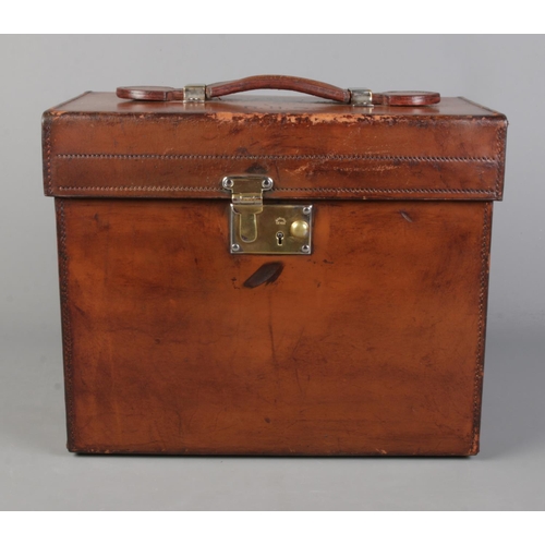 61 - A Victorian brown leather hat case containing a Kirsop & Son top hat. Case monogrammed RHC and havin... 