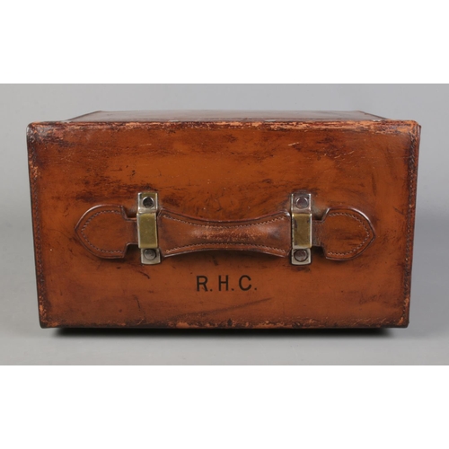 61 - A Victorian brown leather hat case containing a Kirsop & Son top hat. Case monogrammed RHC and havin... 