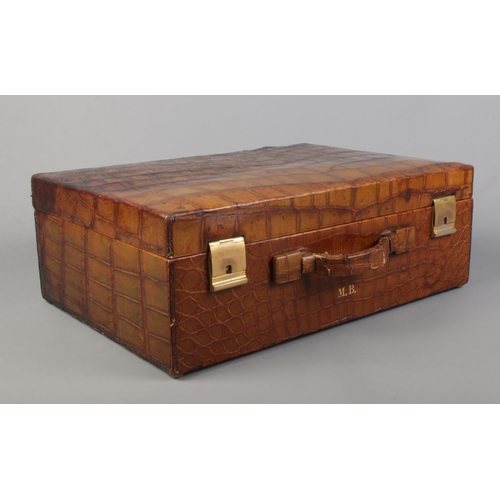 62 - A crocodile skin dressing case by JW Robinson & Co, Los Angeles, with fitted interior and contents o... 