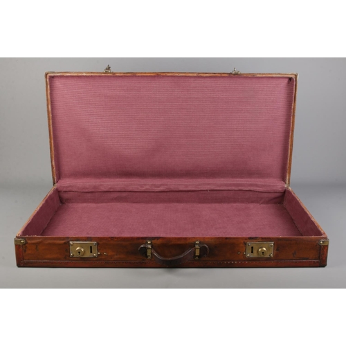 66 - An early 20th century French Moynat leather and metal bound flat travel trunk. Height 13cm, Width 87... 