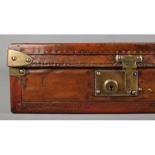 66 - An early 20th century French Moynat leather and metal bound flat travel trunk. Height 13cm, Width 87... 