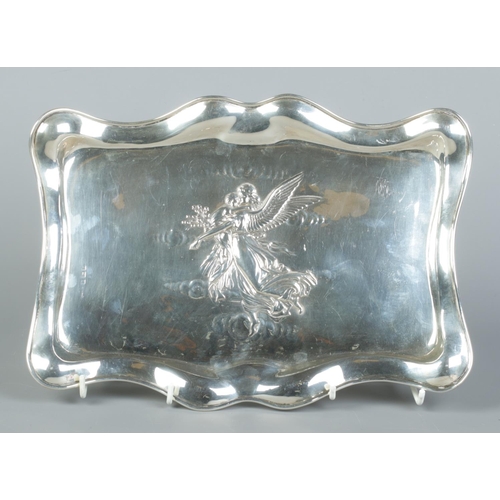 69 - An Edwardian silver dressing table tray with embossed decoration depicting an angel with child. Assa... 