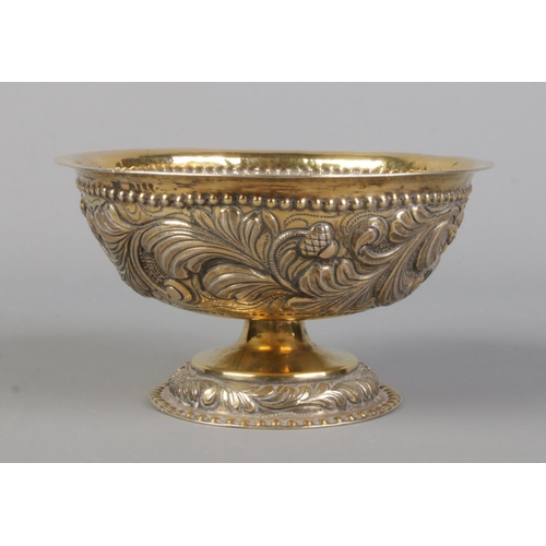 72 - A late 19th century silver gilt pedestal bowl with repousse decoration. London assay marks for 1891 ... 