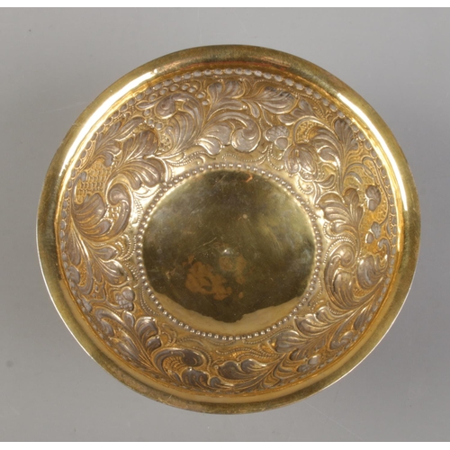 72 - A late 19th century silver gilt pedestal bowl with repousse decoration. London assay marks for 1891 ... 