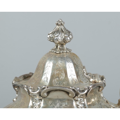 76 - An early Victorian silver teapot. Of hexagonal baluster form and having engraved scrolling decoratio... 