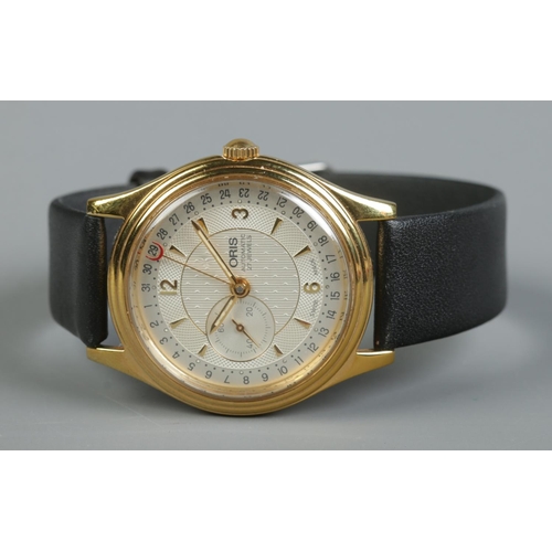84 - A gents gold plated stainless steel Oris automatic wristwatch. Having champagne dial, baton and Arab... 