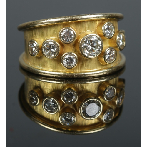86 - An 18ct gold and nine stone diamond ring. Total diamond weight approximately 1.2ct. Size R 1/2. 10.4... 