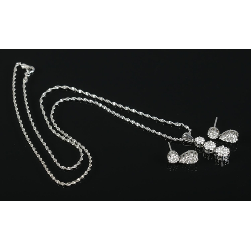 87 - A 14ct white gold and diamond cluster jewellery suite, consisting of drop pendant on chain and pair ... 