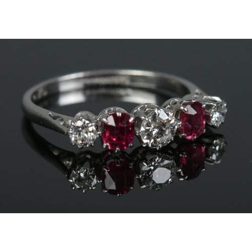97 - An early 20th century platinum, diamond and ruby five stone ring. Size L. 2.59g.