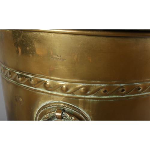 174 - A 19th century brass coal bucket. Raised on four scrolled support, with twin ring handles and having... 