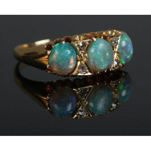 92 - An Edwardian 18ct gold, opal and diamond ring. Size N. 3.99g.