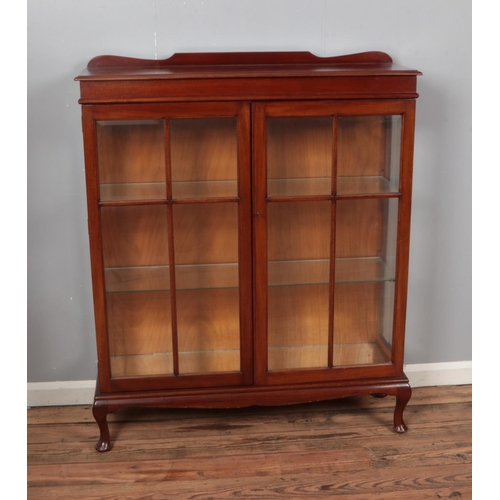 512 - A mahogany display cabinet with two glazed doors with bevelled edge glass and glass interior shelves... 