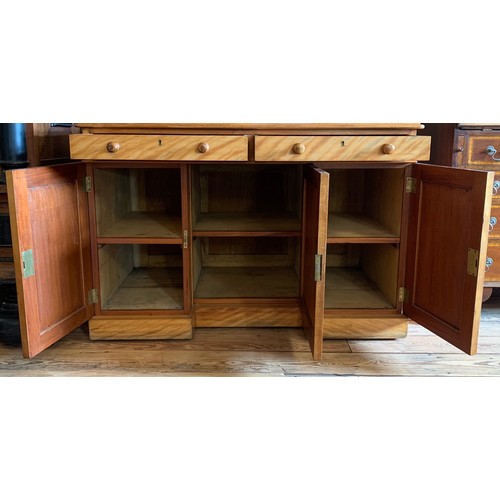 177 - A Victorian satin birch desk. Having two drawers over three cupboard doors. Height 81cm, Width 114cm... 