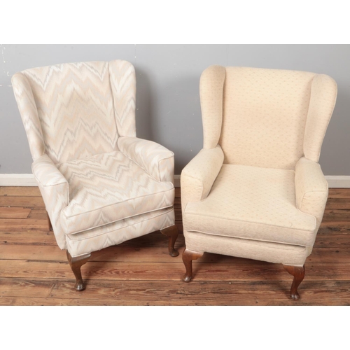 491 - Two upholstered wingback armchairs.